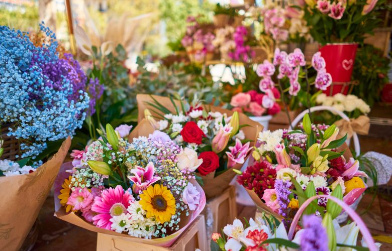 A closeup of colorful flower bouquets in containers at an outdoor shop